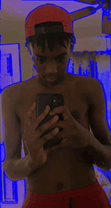 a shirtless man is taking a selfie with his cell phone