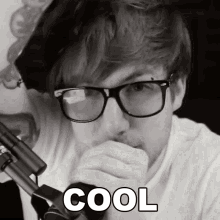 a black and white photo of a man with glasses and the word cool