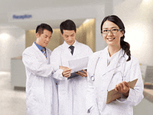 a group of doctors are standing in a hallway with a sign that says reception in the background