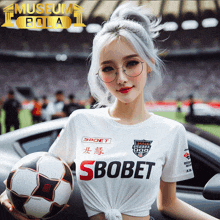 a woman holding a soccer ball wearing a shirt that says ' sbobet ' on it