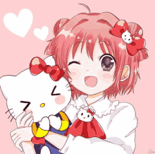 a girl with red hair is holding a hello kitty doll .