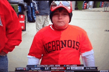 a boy wearing a red shirt that says nebraska