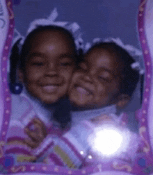 two little girls are posing for a picture in a frame