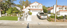 a ford truck is parked in front of a house