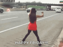 a woman is dancing on the side of a highway .