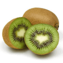 a kiwi fruit is cut in half on a white surface