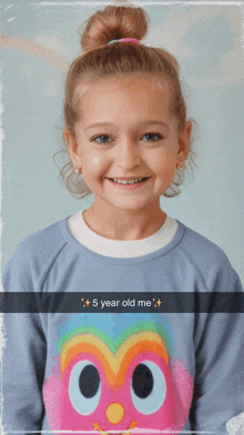 a little girl is wearing a sweater with an owl on it and a caption that says " 5 year old me "