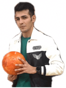 a man wearing a speed hunters jacket holds an orange bowling ball