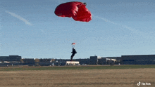 a man is flying through the air with a parachute .