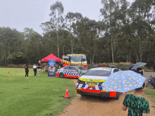 a police car with a license plate that says ' jcg ' on it is parked on a dirt road