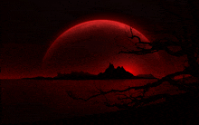 a silhouette of a tree against a red moon