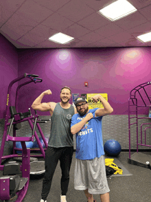 two men flexing their muscles in front of a purple machine that says jump