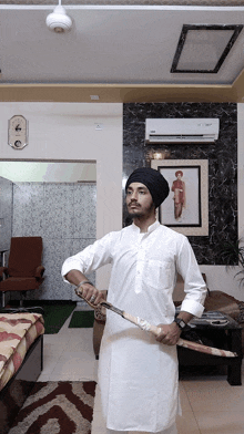 a man in a turban is holding a large sword