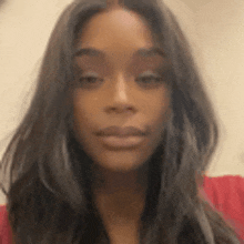 a close up of a woman 's face with long dark hair .