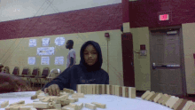 a boy playing dominoes in a gym with a sign that says mindset