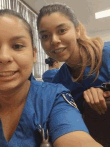 two nurses are posing for a picture and one has a badge that says ' ucsd ' on her shoulder