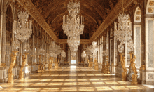 a hallway with lots of chandeliers and statues