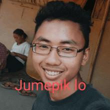 a young man with glasses is smiling with the name jumepik lo written in red