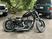 a black motorcycle is parked in front of a toyota tacoma