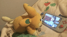 a stuffed animal is sitting next to a nintendo switch