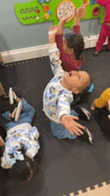 a group of children are playing with a toy in a room