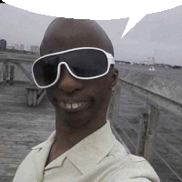 a man wearing sunglasses is taking a selfie on a wooden pier .