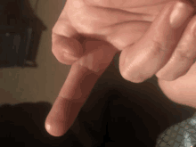 a close up of a person 's finger pointing down