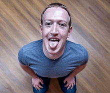 a man is sticking his tongue out while kneeling down