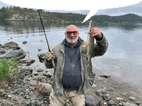 a man is holding a fishing rod and a fish