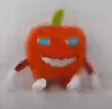 a stuffed orange pumpkin with blue eyes and arms and legs is smiling .