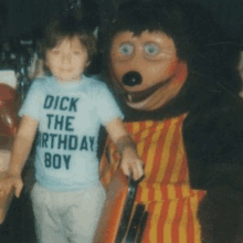 a boy wearing a shirt that says dick the birthday boy