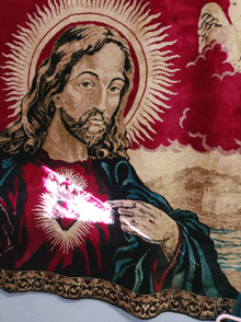 a painting of jesus with a red heart