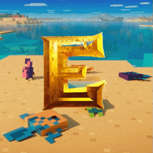 a gold letter e sits on a sandy beach next to a purple box