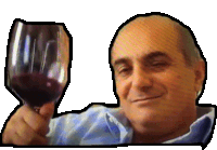 a man is holding a glass of red wine and smiling