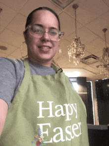 a woman wearing glasses and an apron that says happy easter