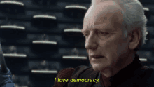 a man says i love democracy in yellow text