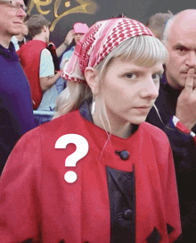 a woman in a red coat has a question mark on her shoulder