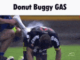 a soccer player is being sprayed with donut buggy gas on the field