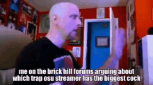 a bald man is standing in front of a blue door and talking about a streamer