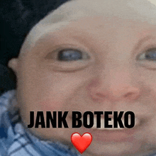 a close up of a baby 's face with the words `` jank boteko '' and a heart .