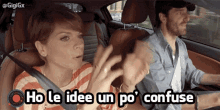 a man and a woman in a car with the words ho le idee un po confuse