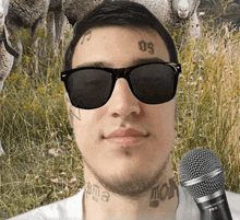 a man wearing sunglasses has a tattoo on his forehead with the number 50