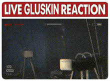 a man in a suit and bow tie is standing in front of a screen that says live gluskin reaction