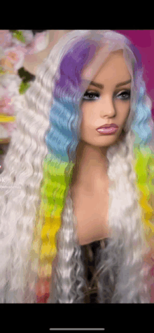 a mannequin wearing a white wig with rainbow colored hair .