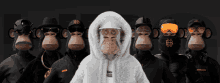 a group of monkeys with one wearing a white hoodie that says ' snoop dogg ' on it