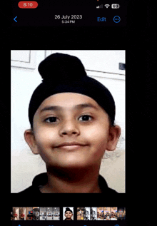 a phone screen shows a picture of a young boy with a turban on and the date 26 july 2023