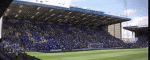 a soccer field with a large crowd in the stands and a sign that says ' king ' on it