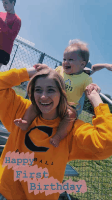 a woman wearing a yellow shirt that says happyball first birthday