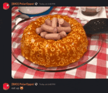 a cake made out of macaroni and cheese with sausages on top