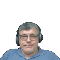 a man wearing a blue shirt and headphones looks at the camera